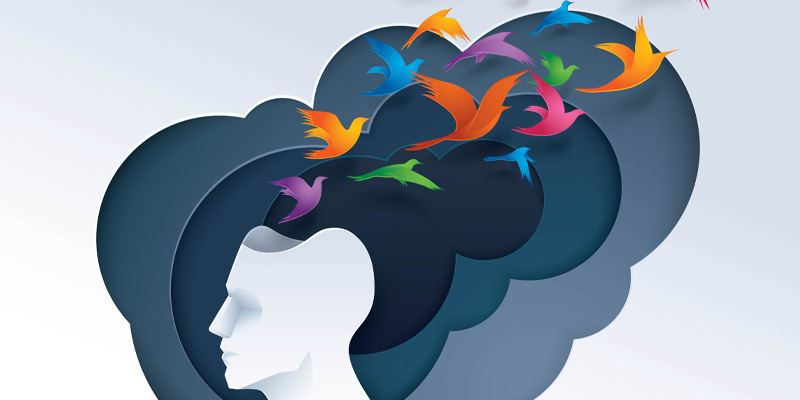 Abstract image of head with colourful birds flying out
